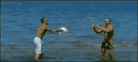 two men are playing with a dog in the water and it is a gif from 4gifs.com