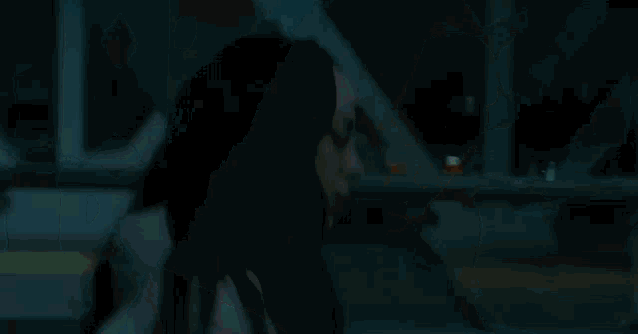 a man is holding a child 's hand in a foggy night .