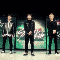 a group of people standing in front of a sign that says ' stray kids '