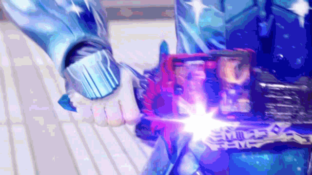 a person is holding a sword that is glowing blue and red .