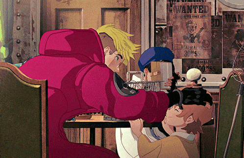 a man in a red coat sits at a table in front of a wall with wanted posters on it