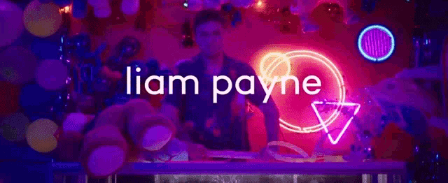 a neon sign that says liam payne on it
