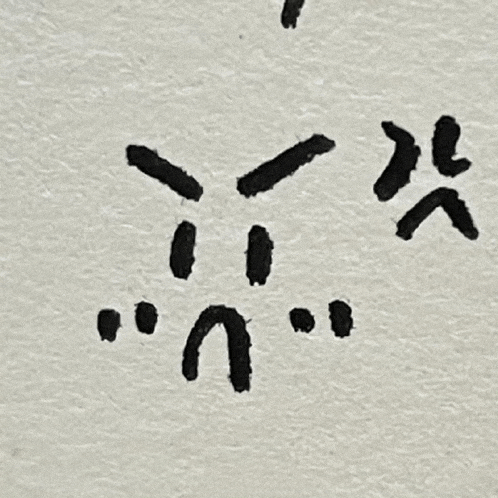 a close up of a piece of paper with a drawing of a face