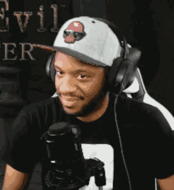 a man wearing headphones and a hat with a mushroom on it