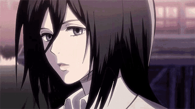 a close up of a person 's face with long black hair and a white shirt .