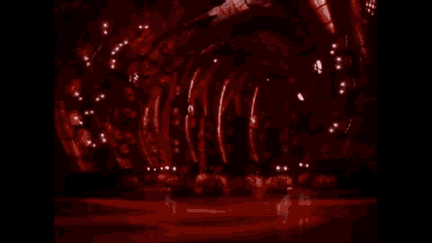a dark room with a few lights on the walls