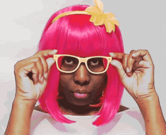 a woman wearing a pink wig and glasses