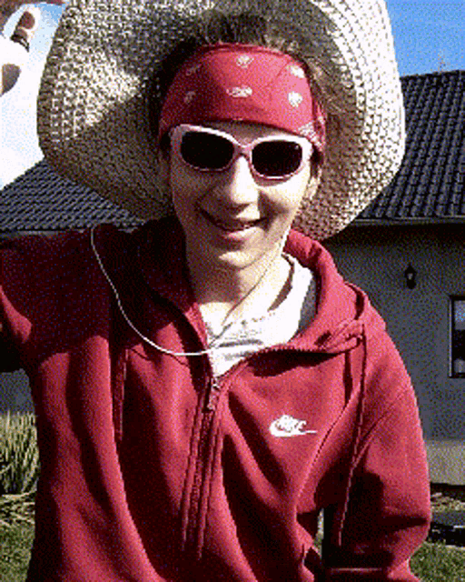 a woman wearing sunglasses and a nike jacket