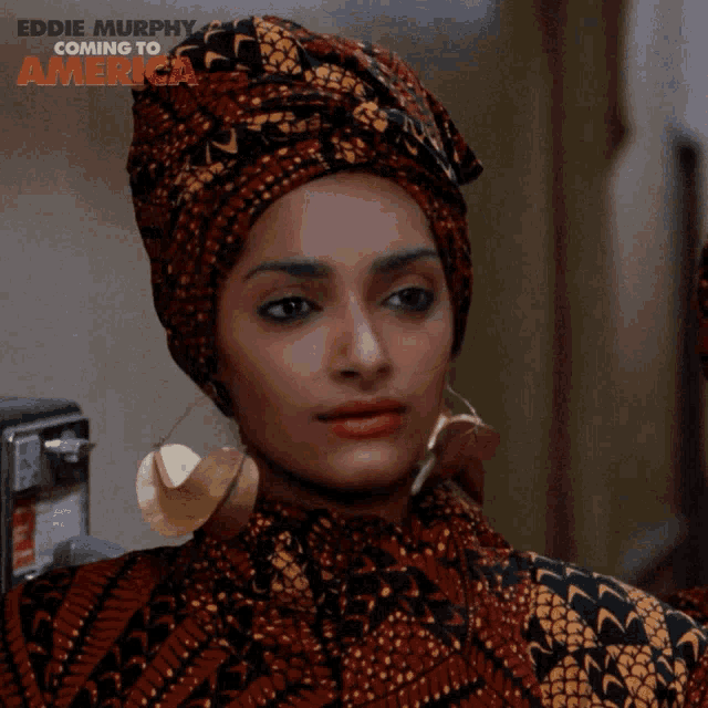 a woman wearing a turban and earrings is a character from eddie murphy coming to america