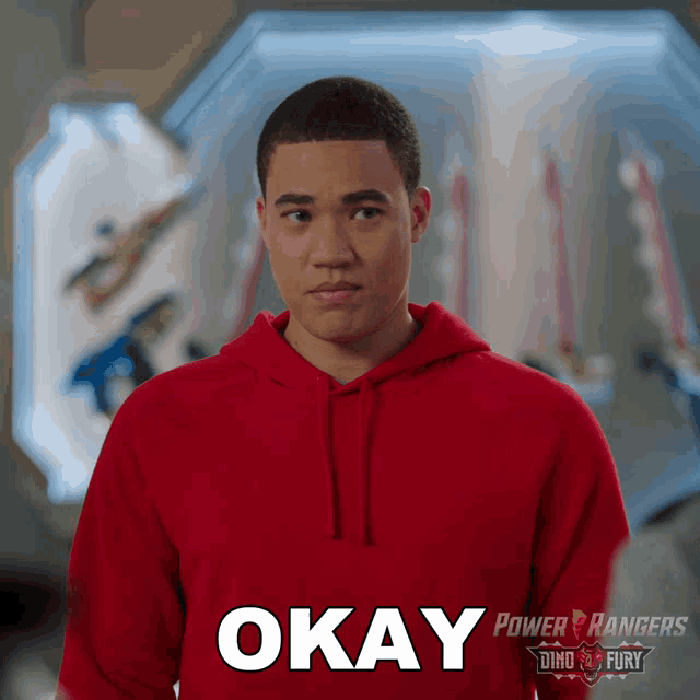 a man wearing a red power rangers hoodie says " okay "
