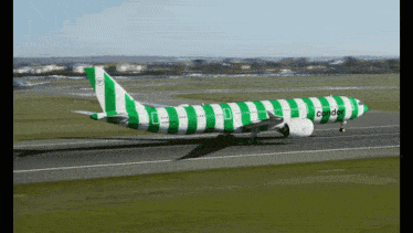 a green and white striped condor plane is taking off