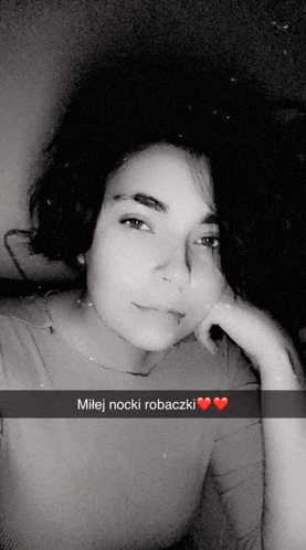 a black and white photo of a woman with the words milej nocki robaczki on the bottom right
