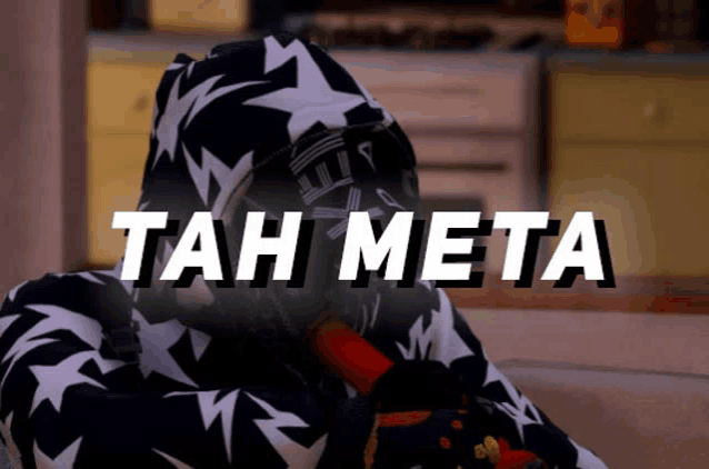 a person in a black and white hoodie with the words tah meta written on the bottom