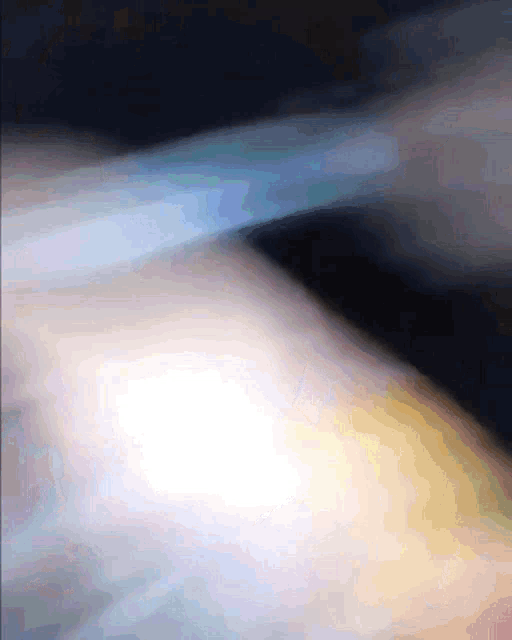 a blurry picture of a person 's arm with a light shining through it