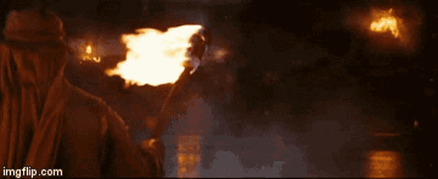 a person is holding a torch in front of their face with imgflip.com written on the bottom