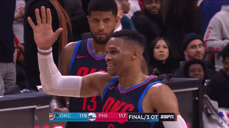 two oklahoma city thunder basketball players are waving at the crowd
