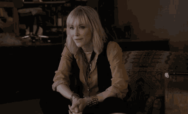 a woman is sitting on a couch with her legs crossed