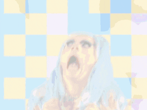a drag queen with blue hair covering her mouth with her hand
