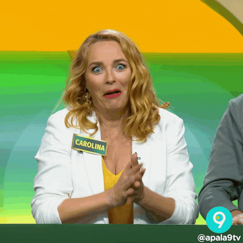a woman with a name tag that says carolina is clapping her hands