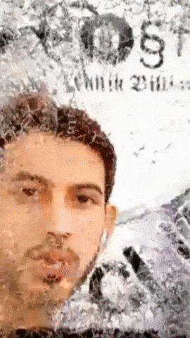 a man 's face is visible in a blurry photo with the word justice visible in the background