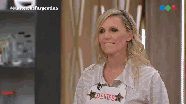 a woman wearing a white apron that says denise on it