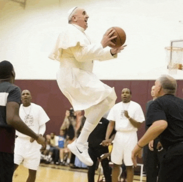 a man in a white robe is holding a basketball and jumping in the air