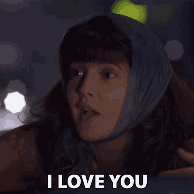 a woman wearing a scarf around her head says i love you