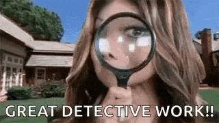 a woman is holding a magnifying glass to her face .