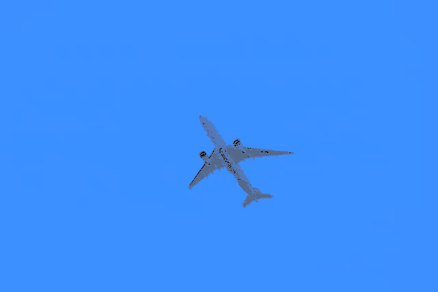 a blue and white airplane is flying in the sky