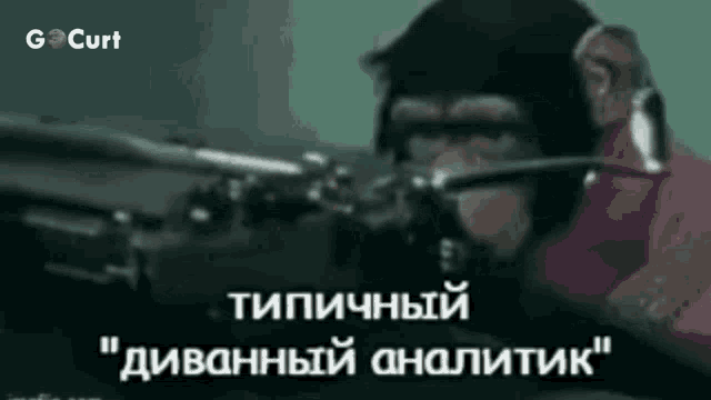 a chimpanzee wearing headphones and a helmet is holding a gun