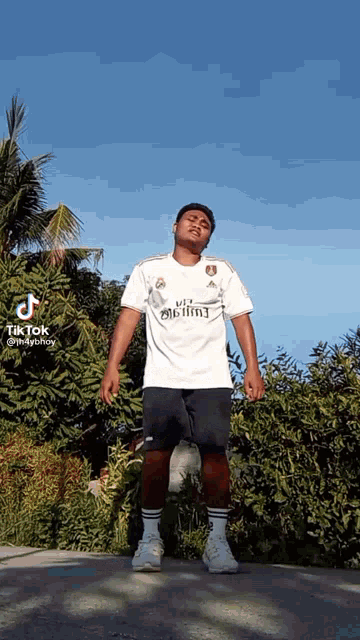a man in a white shirt that says fly emirates