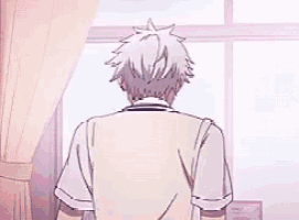 a boy with white hair is holding a cell phone in his hands .