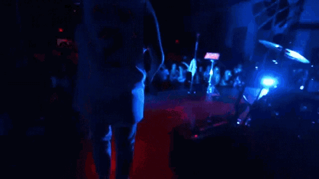 a man in a number 2 jersey stands on a stage in front of a crowd