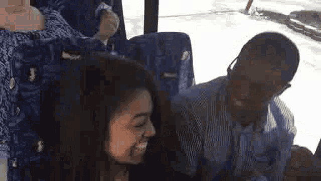 a group of people are sitting on a bus .