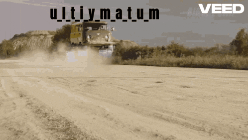 a truck is driving down a dirt road with the words " veed " on the bottom