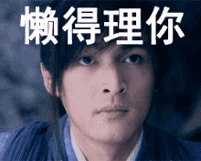 a close up of a man 's face with chinese writing behind him