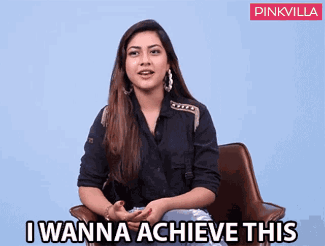 a woman in a black shirt is sitting in a chair and says " i wanna achieve this "