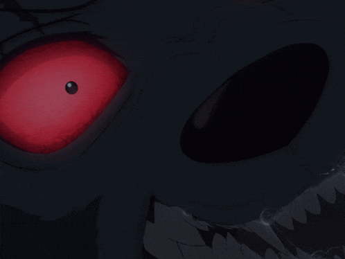 a close up of a monster 's face with red eyes and sharp teeth