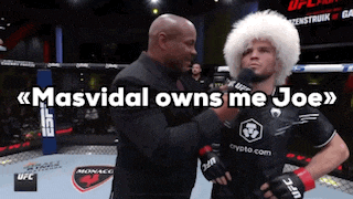 a man in a fur hat talks into a microphone with the words masvidal owns me joe above him