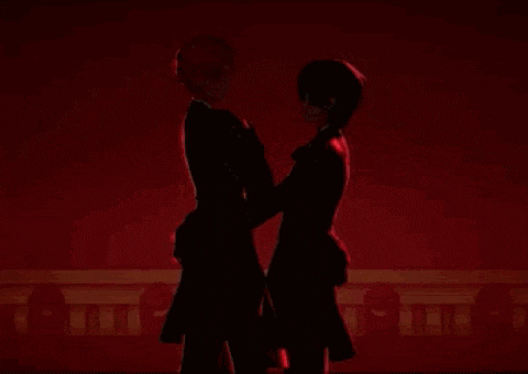 two anime characters are kissing each other in front of a heart .