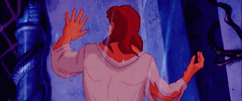 a cartoon character is standing in front of a door and waving his hand .