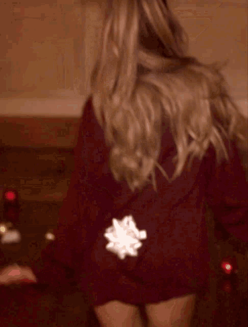 a woman wearing antlers and a red sweater
