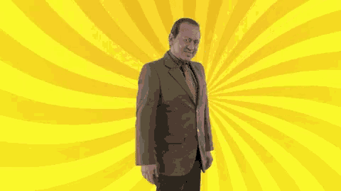 a man in a suit and tie with a yellow background