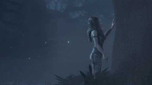 a woman standing next to a tree in a forest