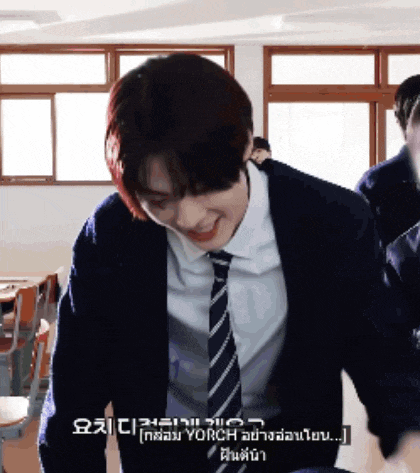 a man in a suit and tie is smiling in a room