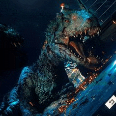 a large dinosaur with its mouth open is standing in front of a building in the dark .