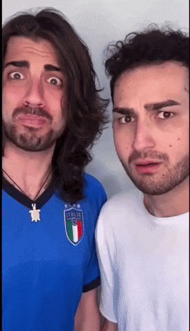 a man with long hair and a beard is wearing a blue jersey with the italian flag on it .