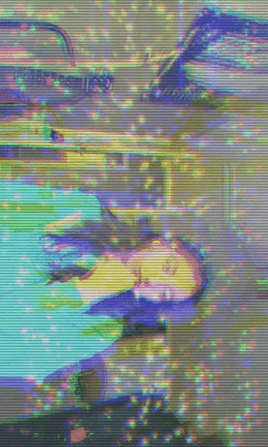 a blurry image of a person laying on a bed with a car in the background