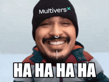 a man wearing a beanie with the word multivers on it laughs