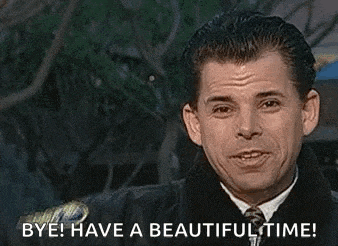 a man in a suit and tie is waving his hand and saying `` bye have a beautiful time '' .